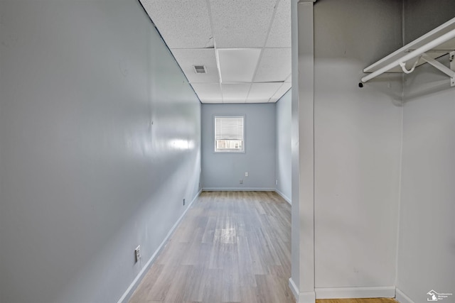 12800 Matthews St, Carleton, MI 48117 - hallway with a paneled ceiling, wood finished floors, and baseboards