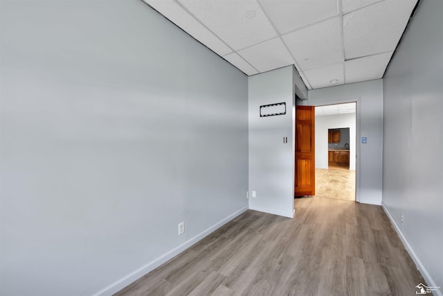 12800 Matthews St, Carleton, MI 48117 - empty room with a drop ceiling, light wood-style floors, and baseboards