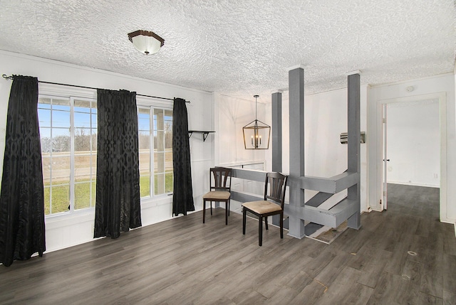 interior space featuring a textured ceiling and wood finished floors