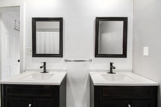 bathroom with two vanities and a sink