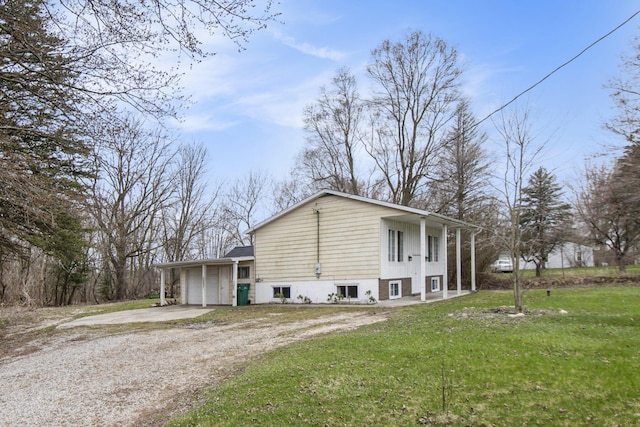 view of side of property featuring a garage, a yard, and driveway