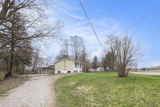 exterior space with an attached garage, a lawn, and driveway