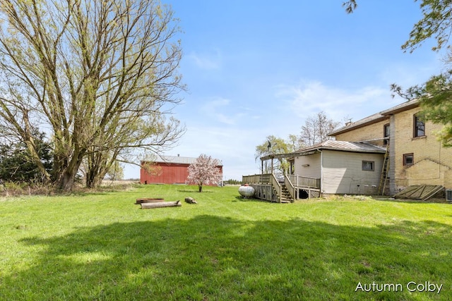 view of yard with a deck and an outdoor structure