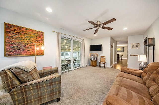 living area featuring recessed lighting, baseboards, a ceiling fan, and carpet floors