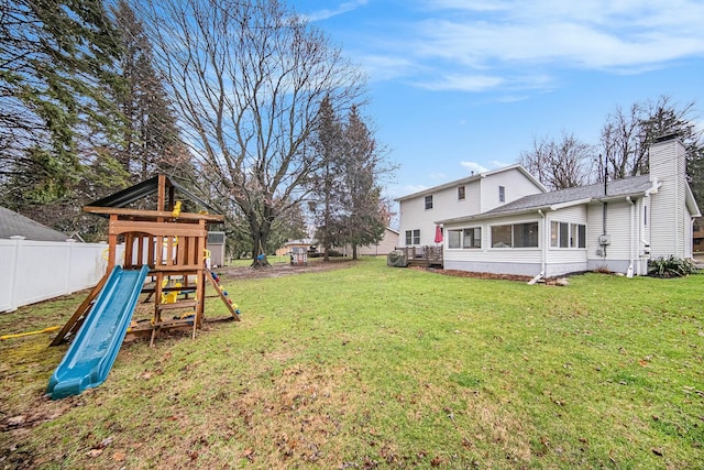 view of yard featuring fence and a playground