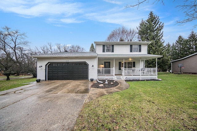 view of front of home with a front yard, driveway, an attached garage, and covered porch