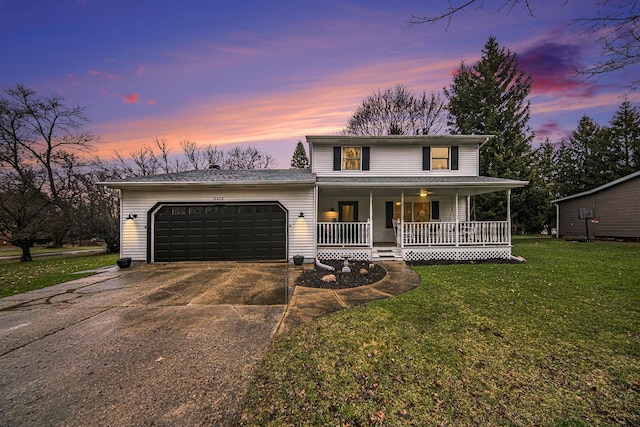 view of front of property featuring covered porch, a garage, concrete driveway, a front lawn, and roof with shingles