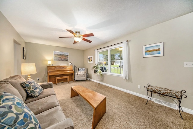 living area with baseboards, a ceiling fan, and carpet flooring