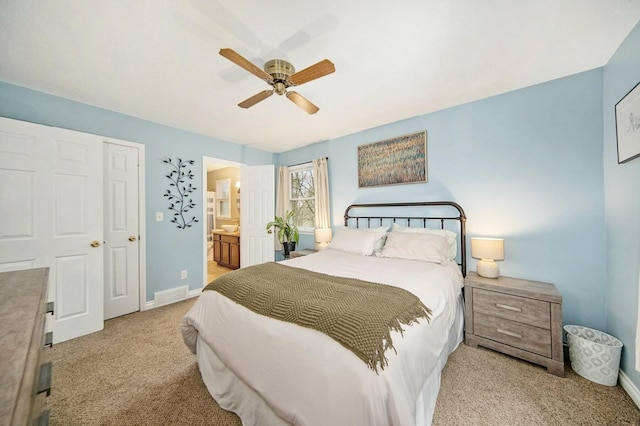 carpeted bedroom with visible vents, baseboards, connected bathroom, and ceiling fan