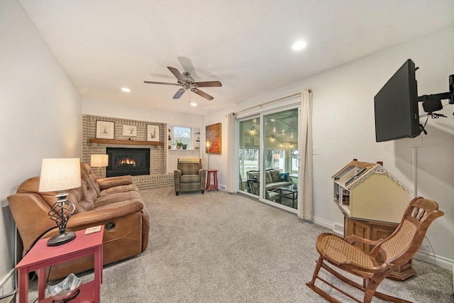 living room with recessed lighting, carpet flooring, a brick fireplace, and ceiling fan