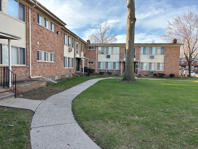 view of home's community featuring a residential view and a lawn