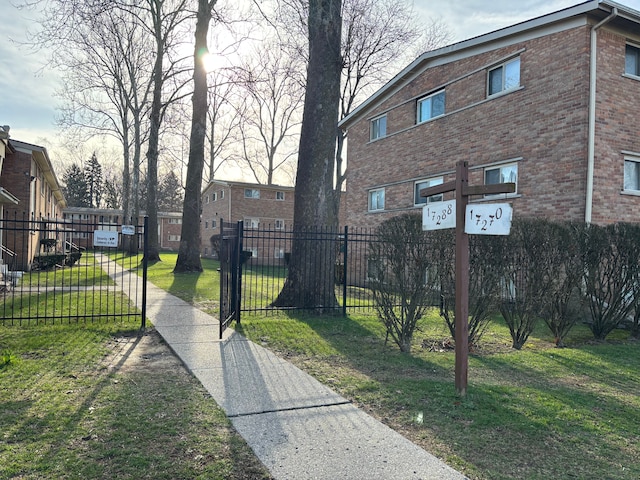 exterior space with fence and a lawn