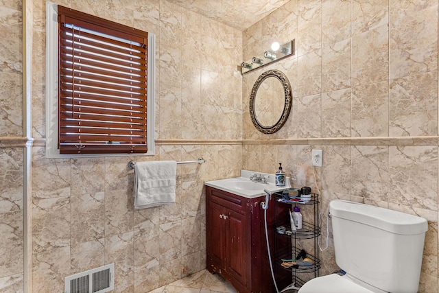 6624 Mead St, Dearborn, MI 48126 - bathroom with visible vents, toilet, vanity, and tile walls