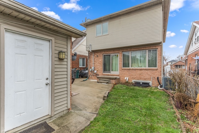 6624 Mead St, Dearborn, MI 48126 - rear view of house featuring central AC unit, entry steps, a patio area, a lawn, and brick siding