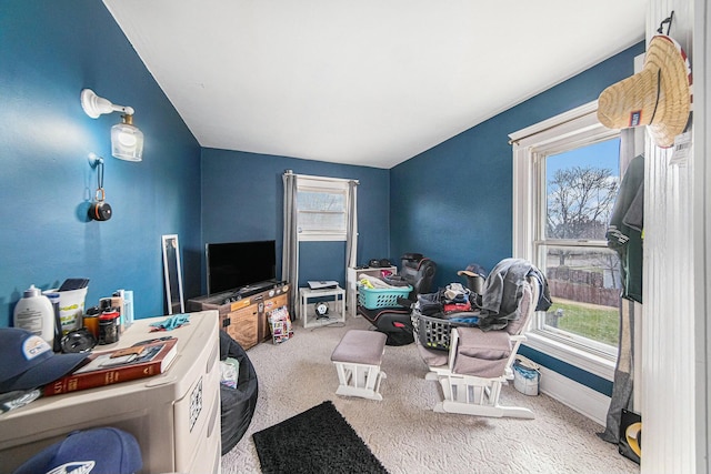 carpeted living room with baseboards