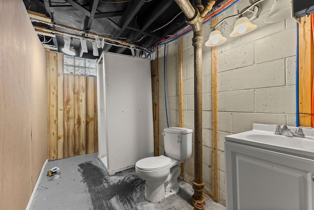 bathroom featuring vanity, unfinished concrete flooring, and toilet