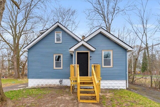 bungalow with fence and a chimney