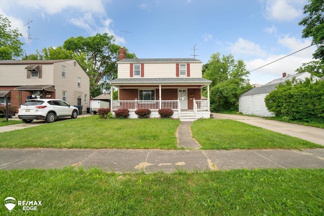 514 Chalmers St, Flint, MI 48503 - view of front of property with covered porch, a front yard, brick siding, and a chimney