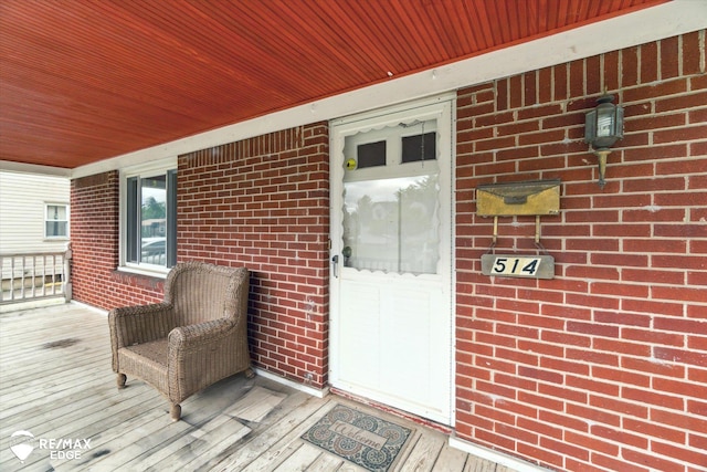 514 Chalmers St, Flint, MI 48503 - doorway to property with brick siding and a porch