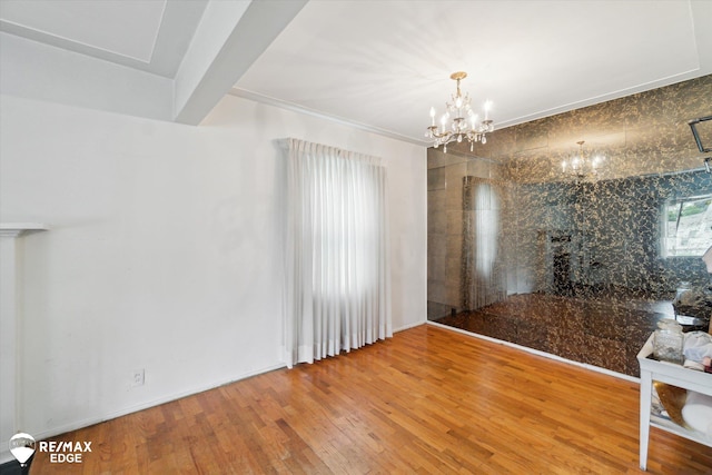 514 Chalmers St, Flint, MI 48503 - unfurnished dining area featuring a chandelier and wood finished floors