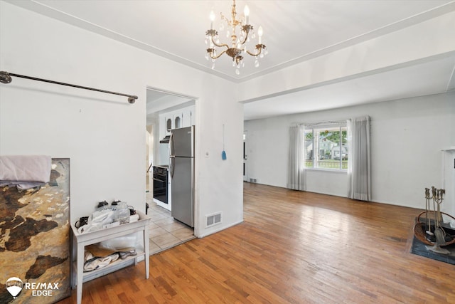 514 Chalmers St, Flint, MI 48503 - living room featuring wood finished floors and a chandelier