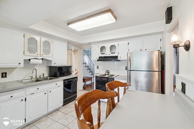 514 Chalmers St, Flint, MI 48503 - kitchen with black appliances, a sink, under cabinet range hood, decorative backsplash, and white cabinets