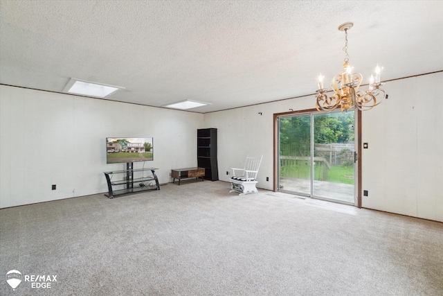 514 Chalmers St, Flint, MI 48503 - carpeted empty room featuring a chandelier and a textured ceiling
