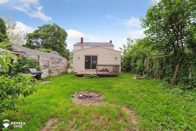 514 Chalmers St, Flint, MI 48503 - back of property featuring a deck, a yard, and a chimney