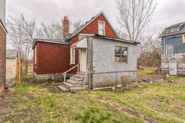 exterior space featuring entry steps and a chimney
