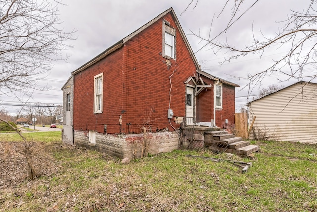 rear view of property with brick siding