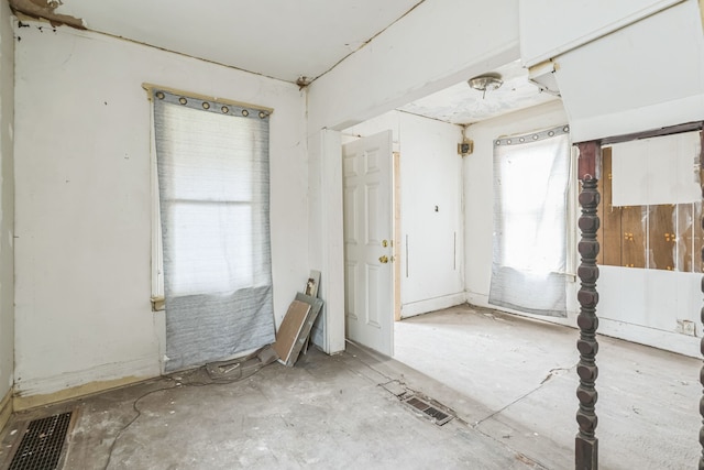 unfurnished room featuring visible vents