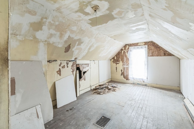 additional living space with visible vents and vaulted ceiling