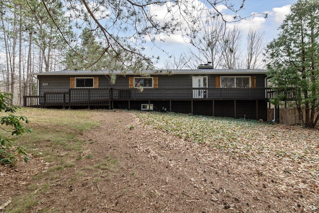 323 13th St, Plainwell, MI 49080 - rear view of house with a deck and a chimney
