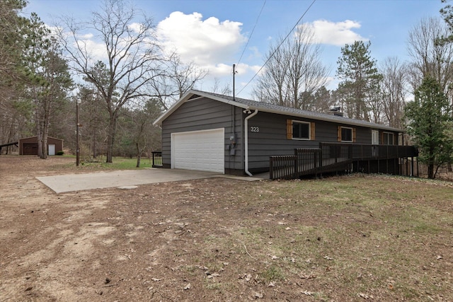 323 13th St, Plainwell, MI 49080 - garage featuring concrete driveway
