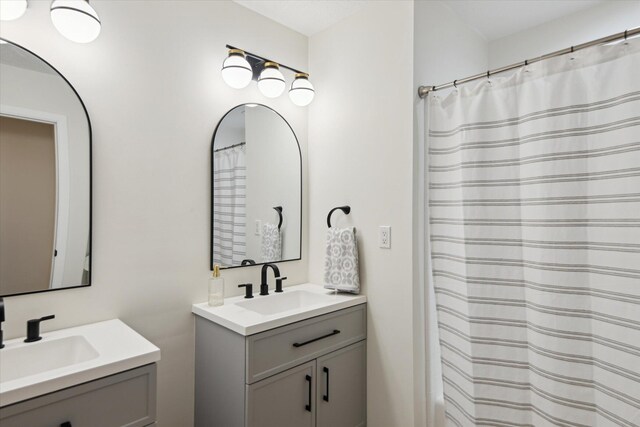 323 13th St, Plainwell, MI 49080 - bathroom featuring two vanities and a sink