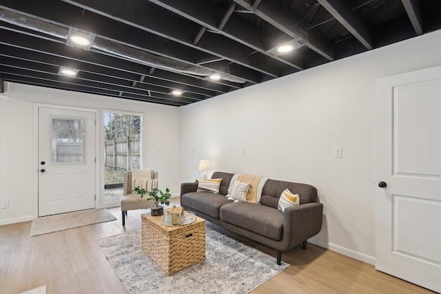 323 13th St, Plainwell, MI 49080 - living area with light wood-style floors and baseboards