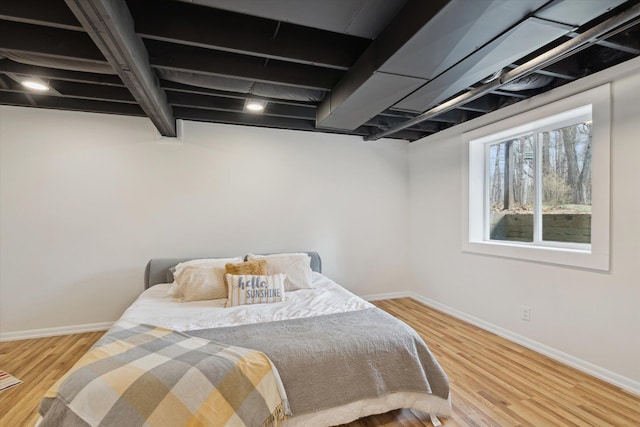 323 13th St, Plainwell, MI 49080 - bedroom featuring beam ceiling, baseboards, and wood finished floors