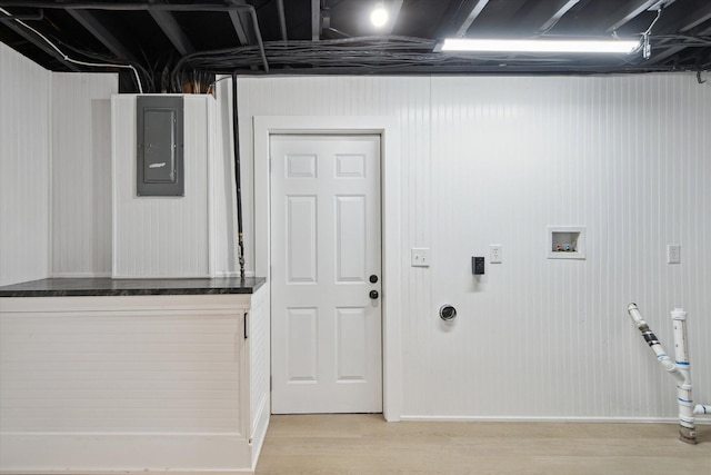 323 13th St, Plainwell, MI 49080 - laundry area with electric panel, light wood-style floors, and laundry area