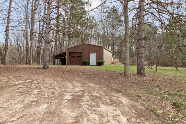 323 13th St, Plainwell, MI 49080 - view of pole building featuring driveway