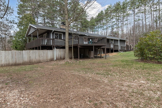 323 13th St, Plainwell, MI 49080 - back of property featuring a chimney, fence, a deck, and a yard