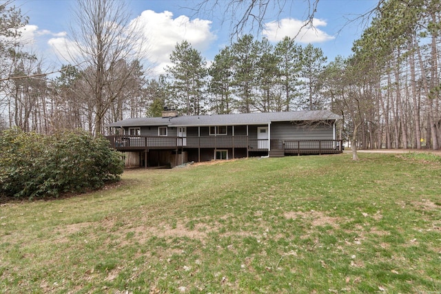 323 13th St, Plainwell, MI 49080 - rear view of property with a wooden deck, a lawn, and a chimney