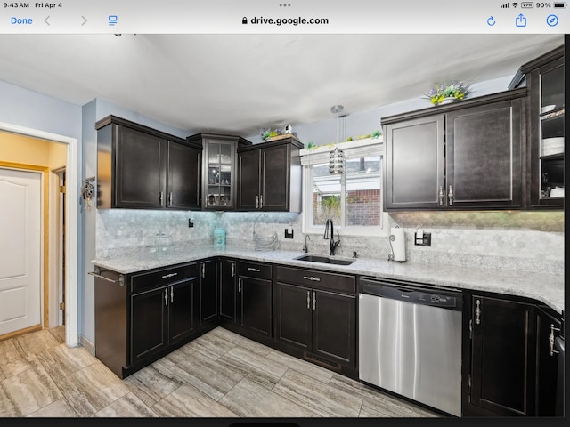 27908 Ryan Rd, Warren, MI 48092 - kitchen featuring dishwasher, a sink, tasteful backsplash, glass insert cabinets, and light stone counters