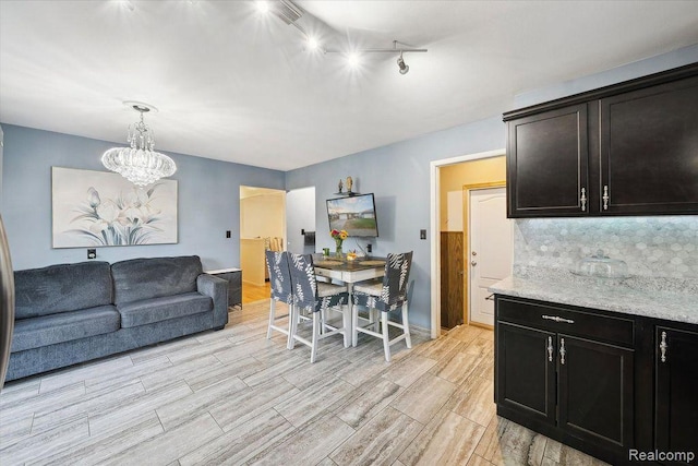 27908 Ryan Rd, Warren, MI 48092 - dining space with light wood-style flooring, a chandelier, and rail lighting