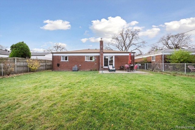 27908 Ryan Rd, Warren, MI 48092 - rear view of property featuring brick siding, a fenced backyard, a chimney, and a patio