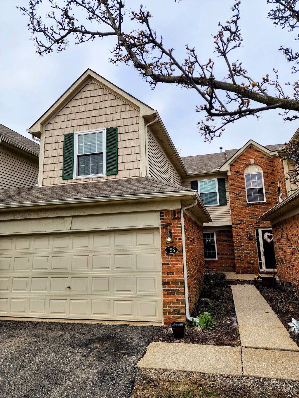 198 Legacy Park Cir Unit 71, Dearborn Heights, MI 48127 - view of front of home with brick siding, a garage, and aphalt driveway