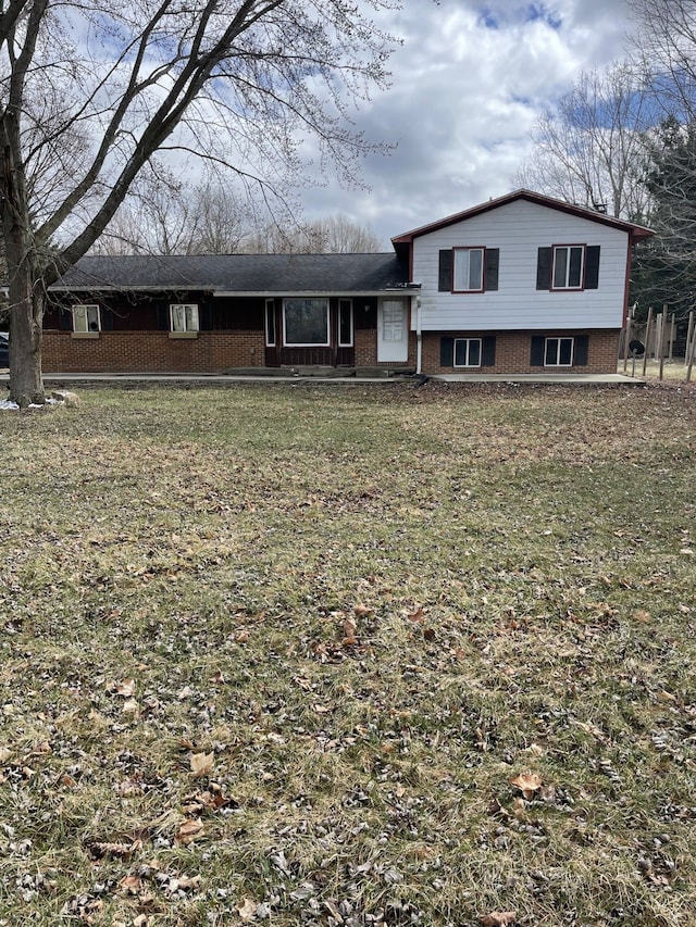 tri-level home with a front lawn