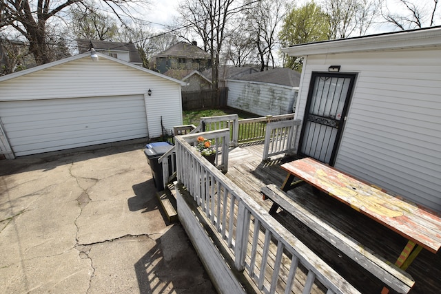 722 E 6th St, Flint, MI 48503 - deck featuring fence, a garage, and an outbuilding