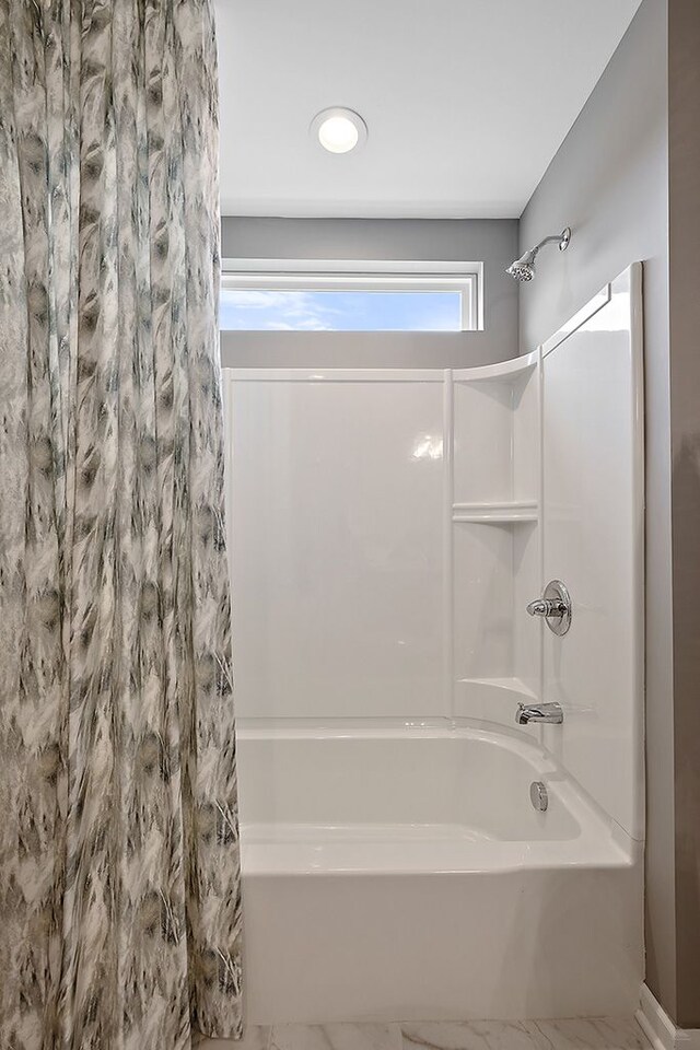 518 Cannonade Loop, Howell, MI 48843 - bathroom featuring shower / bath combo with shower curtain