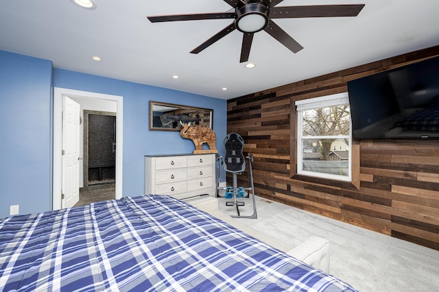 bedroom with wood walls, recessed lighting, ensuite bathroom, and a ceiling fan