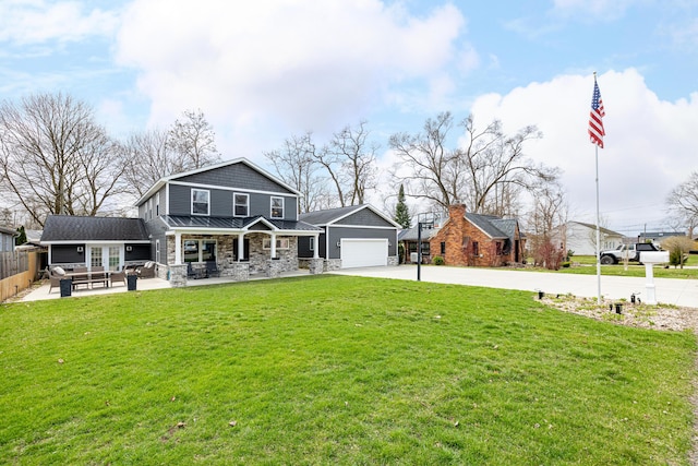back of house featuring an outdoor hangout area, a lawn, fence, a garage, and concrete driveway